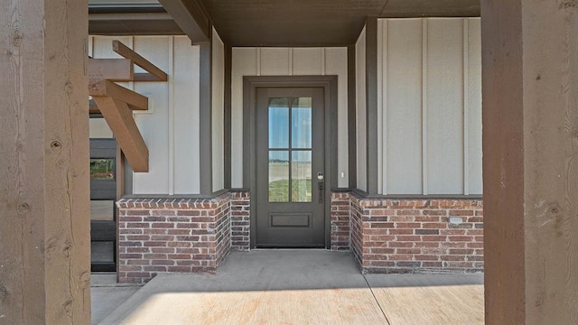 4676 Ranchero Dr, Edmond, OK 73025 - view of exterior entry with board and batten siding and brick siding