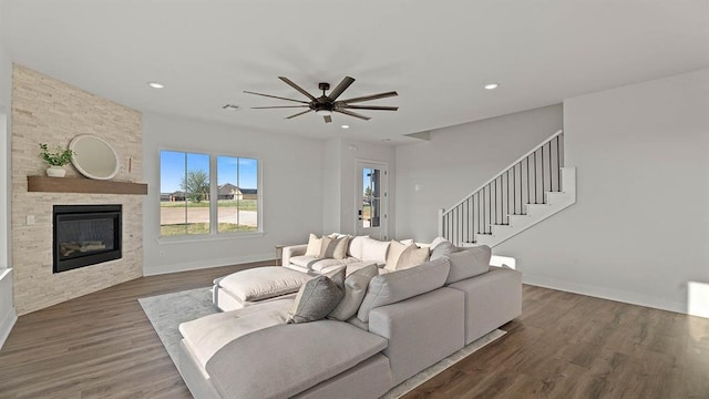 4676 Ranchero Dr, Edmond, OK 73025 - living area featuring a ceiling fan, a large fireplace, dark wood-type flooring, stairs, and recessed lighting