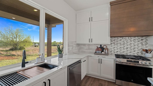 4676 Ranchero Dr, Edmond, OK 73025 - kitchen with appliances with stainless steel finishes, extractor fan, and white cabinetry