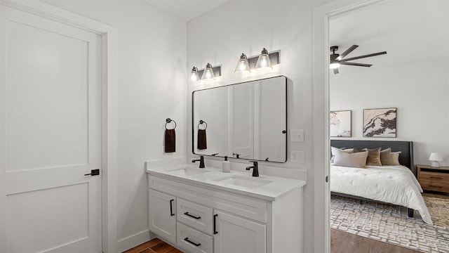 4676 Ranchero Dr, Edmond, OK 73025 - ensuite bathroom with double vanity, wood finished floors, and ceiling fan