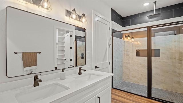 4676 Ranchero Dr, Edmond, OK 73025 - full bathroom featuring a stall shower, double vanity, wood finished floors, and recessed lighting