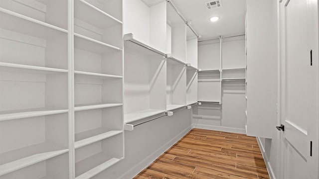 4676 Ranchero Dr, Edmond, OK 73025 - walk in closet featuring wood finished floors