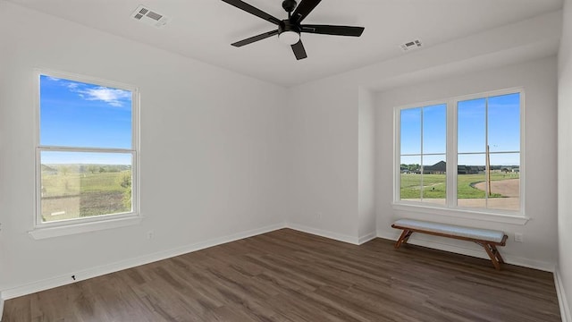 4676 Ranchero Dr, Edmond, OK 73025 - unfurnished room with healthy amount of natural light, dark wood-style flooring, and a ceiling fan