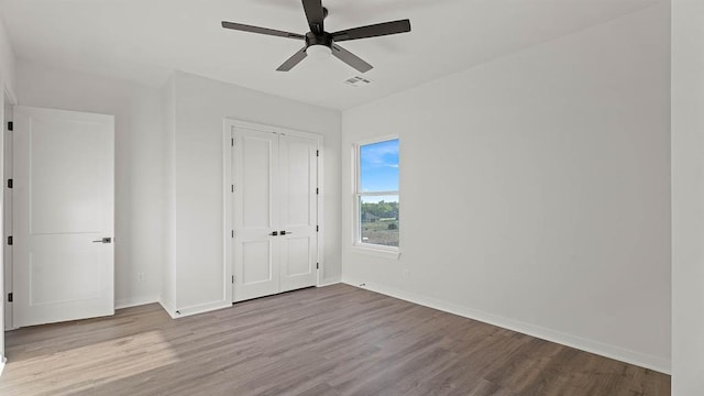 4676 Ranchero Dr, Edmond, OK 73025 - unfurnished bedroom featuring wood finished floors, a closet, and a ceiling fan