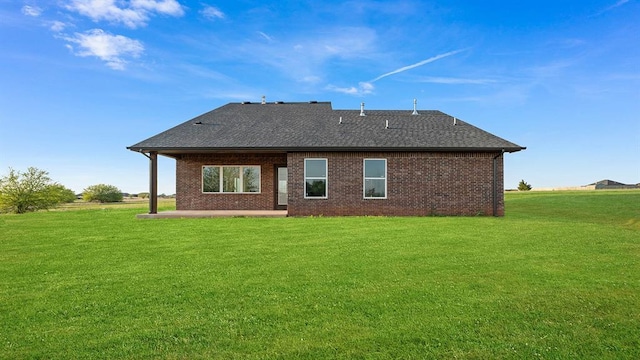 4676 Ranchero Dr, Edmond, OK 73025 - back of house featuring a patio, brick siding, a lawn, and roof with shingles
