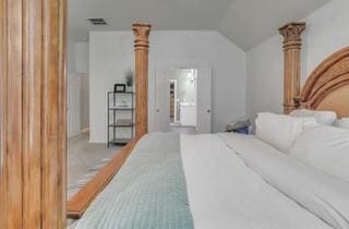 17009 Wales Green Ave, Edmond, OK 73012 - carpeted bedroom with lofted ceiling and ensuite bath