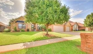 17009 Wales Green Ave, Edmond, OK 73012 - view of front facade featuring a front lawn, driveway, and an attached garage