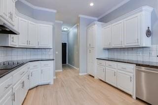 17009 Wales Green Ave, Edmond, OK 73012 - kitchen featuring dishwasher, black electric cooktop, dark countertops, exhaust hood, and tasteful backsplash
