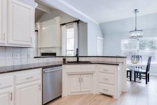 17009 Wales Green Ave, Edmond, OK 73012 - kitchen featuring stainless steel dishwasher, light wood finished floors, a chandelier, dark countertops, and vaulted ceiling