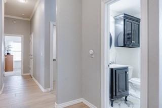 17009 Wales Green Ave, Edmond, OK 73012 - hallway featuring crown molding and light wood-style flooring