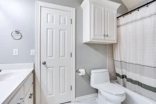 17009 Wales Green Ave, Edmond, OK 73012 - full bathroom with vanity and shower / bathtub combination with curtain