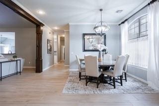 17009 Wales Green Ave, Edmond, OK 73012 - dining space with a chandelier, ornamental molding, wood finished floors, and plenty of natural light