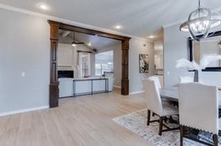 17009 Wales Green Ave, Edmond, OK 73012 - dining space with crown molding, a chandelier, wood finished floors, recessed lighting, and lofted ceiling