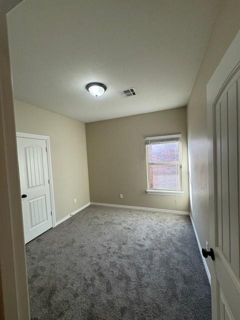 8017 NW 159th St, Edmond, OK 73013 - spare room featuring carpet flooring