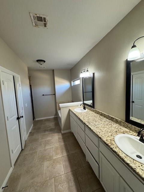 8017 NW 159th St, Edmond, OK 73013 - full bathroom featuring double vanity and a tub to relax in