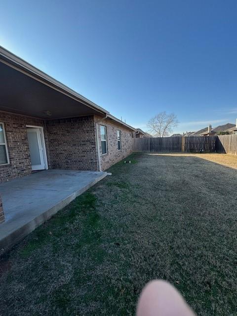8017 NW 159th St, Edmond, OK 73013 - fenced backyard with a patio area