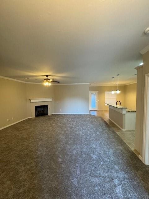 8017 NW 159th St, Edmond, OK 73013 - unfurnished living room featuring crown molding, a ceiling fan, carpet, and a fireplace