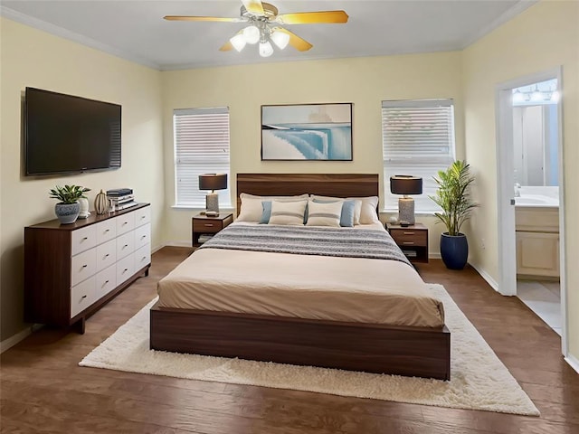 13625 Bell Ave, Oklahoma City, OK 73142 - bedroom featuring multiple windows, connected bathroom, a ceiling fan, wood finished floors, and crown molding