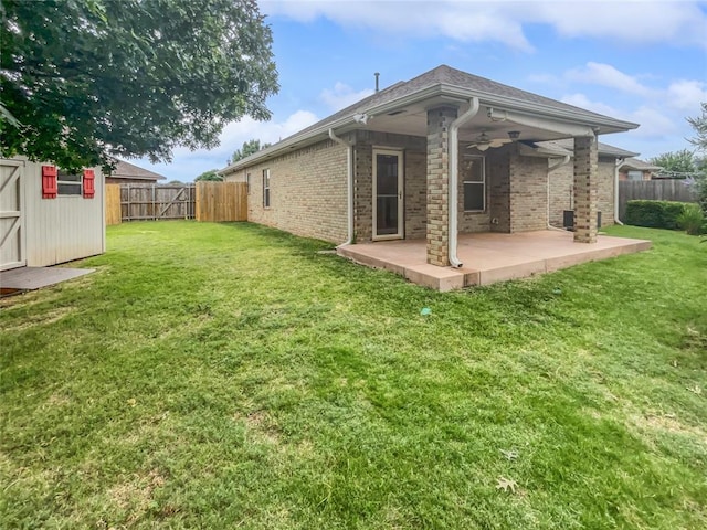 13625 Bell Ave, Oklahoma City, OK 73142 - back of house featuring a patio area, ceiling fan, a fenced backyard, and brick siding
