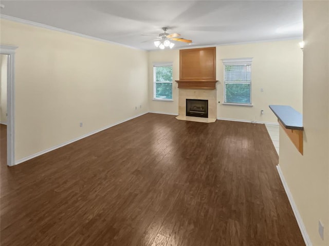 13625 Bell Ave, Oklahoma City, OK 73142 - unfurnished living room with a ceiling fan, dark wood-style flooring, a large fireplace, and ornamental molding