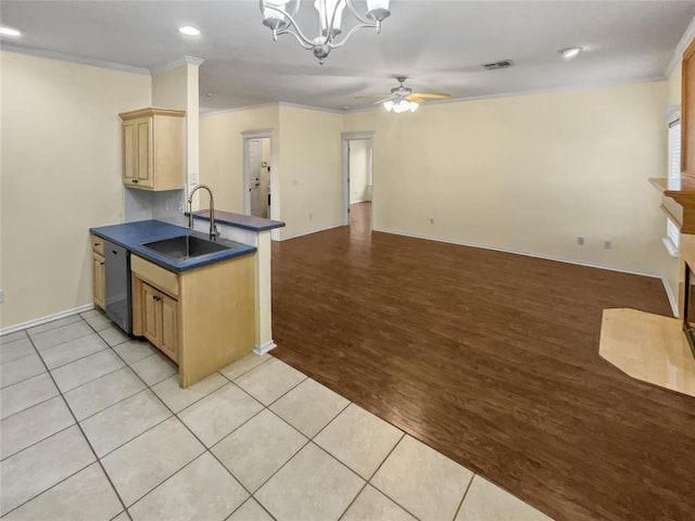 13625 Bell Ave, Oklahoma City, OK 73142 - kitchen with stainless steel dishwasher, dark countertops, ornamental molding, ceiling fan, and light brown cabinets