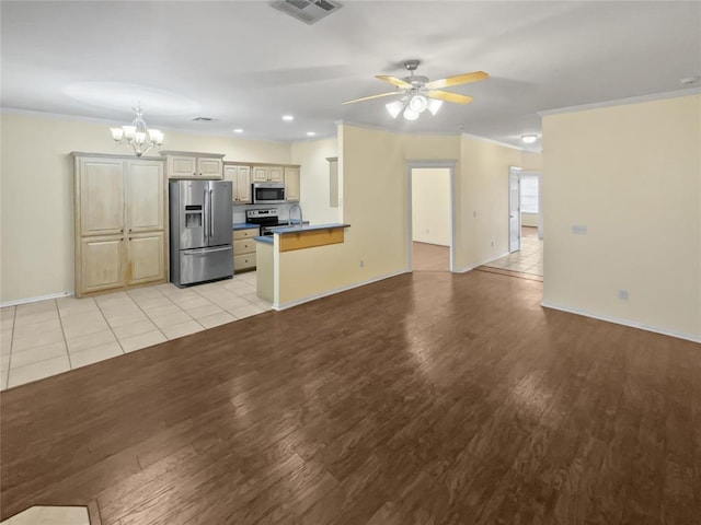 13625 Bell Ave, Oklahoma City, OK 73142 - unfurnished living room featuring a chandelier, light wood-type flooring, crown molding, ceiling fan, and recessed lighting