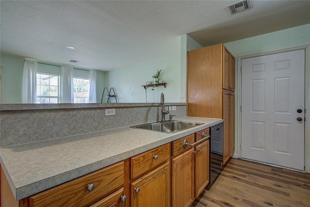 2013 Creekridge Dr, Oklahoma City, OK 73141 - kitchen featuring brown cabinets, light wood-style floors, light countertops, and black dishwasher