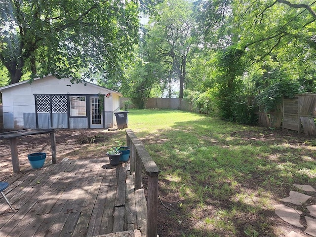 25 E Severn St, Shawnee, OK 74801 - fenced backyard with a wooden deck and an outdoor structure