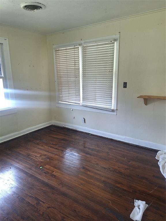 25 E Severn St, Shawnee, OK 74801 - spare room featuring crown molding and hardwood / wood-style flooring