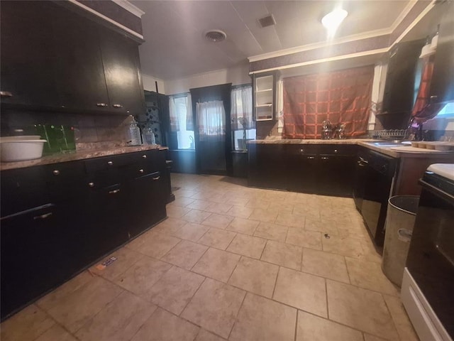25 E Severn St, Shawnee, OK 74801 - kitchen with ornamental molding, range with gas cooktop, dark cabinetry, tasteful backsplash, and light tile patterned flooring