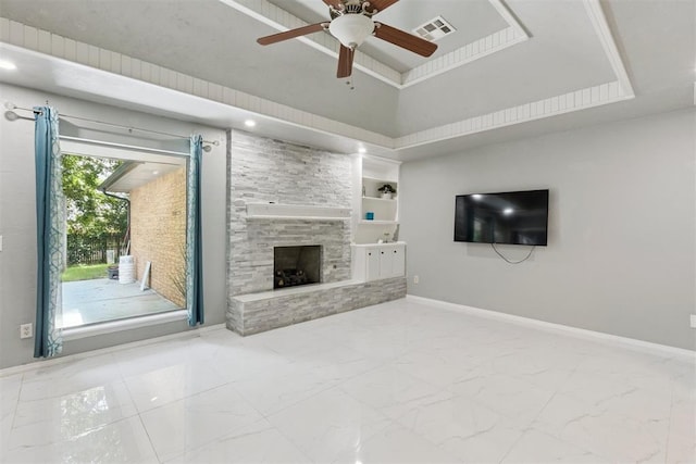 10412 NW 37th St, Yukon, OK 73099 - unfurnished living room with marble finish floors, ceiling fan, a stone fireplace, and built in shelves