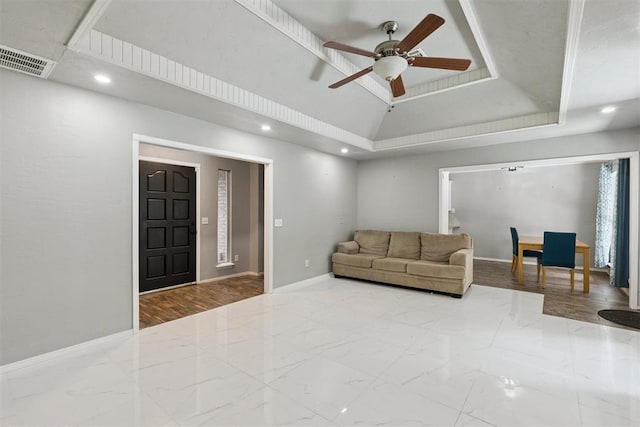 10412 NW 37th St, Yukon, OK 73099 - living room featuring recessed lighting, ceiling fan, a tray ceiling, and marble finish flooring