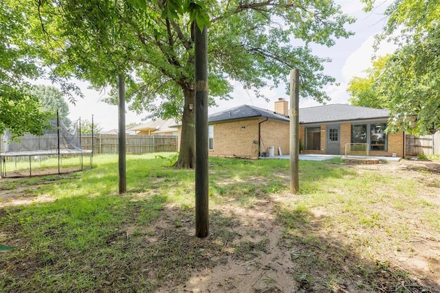 10412 NW 37th St, Yukon, OK 73099 - fenced backyard featuring a trampoline and a patio
