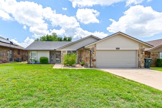 10520 Ricky Ln, Midwest City, OK 73130 - view of front of property featuring concrete driveway, an attached garage, a front lawn, and stone siding
