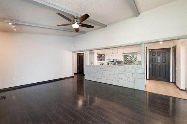 10520 Ricky Ln, Midwest City, OK 73130 - unfurnished living room featuring ceiling fan, light wood-style flooring, and a textured ceiling