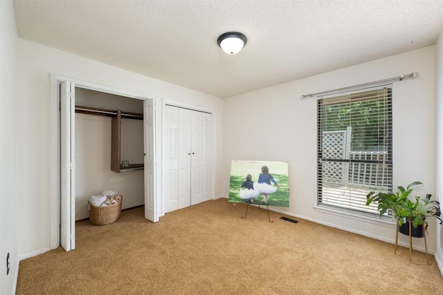 10520 Ricky Ln, Midwest City, OK 73130 - carpeted bedroom with multiple closets and a textured ceiling
