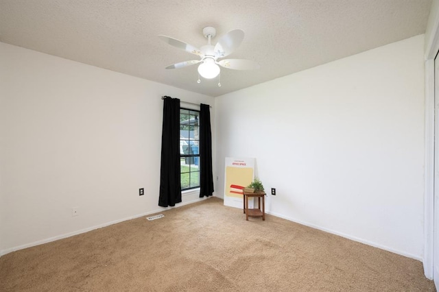 10520 Ricky Ln, Midwest City, OK 73130 - spare room with light colored carpet, a ceiling fan, and a textured ceiling