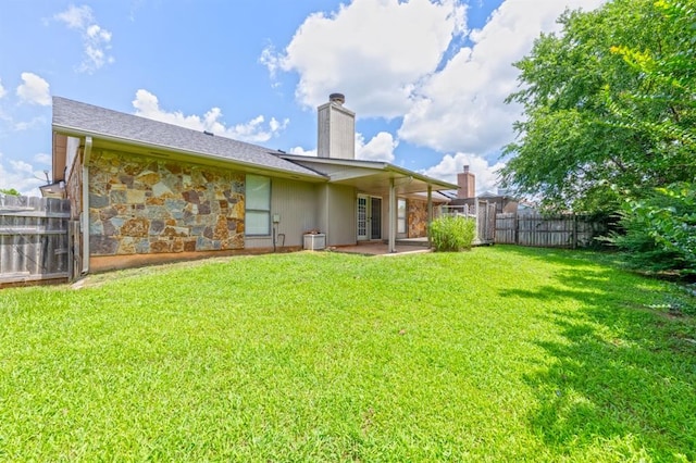 10520 Ricky Ln, Midwest City, OK 73130 - rear view of property featuring a chimney, a patio, and stone siding