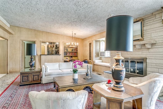 2532 Lancaster Ln, Oklahoma City, OK 73116 - living area with lofted ceiling, a textured ceiling, a chandelier, wooden walls, and a stone fireplace