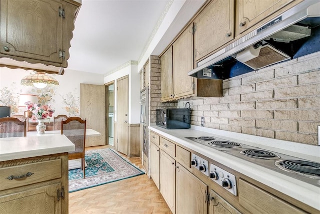 2532 Lancaster Ln, Oklahoma City, OK 73116 - kitchen featuring stainless steel electric stovetop, black microwave, under cabinet range hood, light countertops, and a wainscoted wall