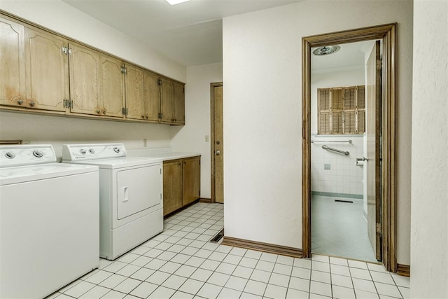 2532 Lancaster Ln, Oklahoma City, OK 73116 - laundry area featuring washing machine and clothes dryer, cabinet space, and light tile patterned floors