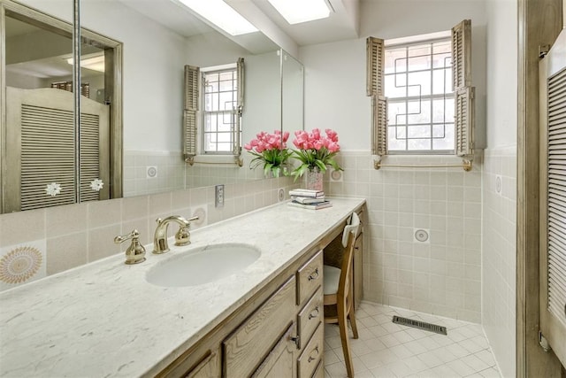 2532 Lancaster Ln, Oklahoma City, OK 73116 - bathroom with tile walls, tile patterned floors, vanity, and a wainscoted wall