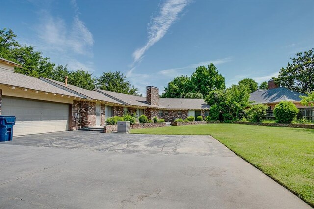 2532 Lancaster Ln, Oklahoma City, OK 73116 - single story home featuring a front yard, driveway, a garage, and a chimney
