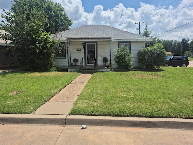 621 S 9th St, Yukon, OK 73099 - bungalow with a front yard, a shingled roof, and a porch