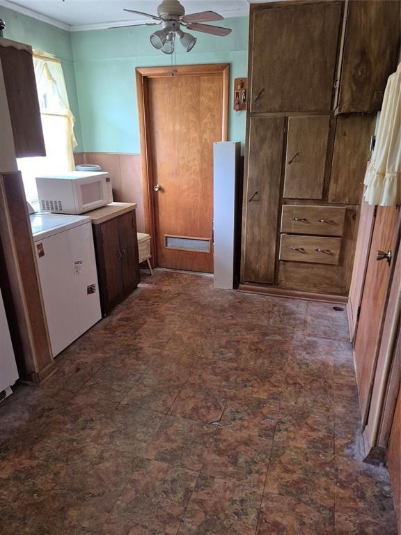 621 S 9th St, Yukon, OK 73099 - kitchen with white microwave, a ceiling fan, ornamental molding, and washer / dryer