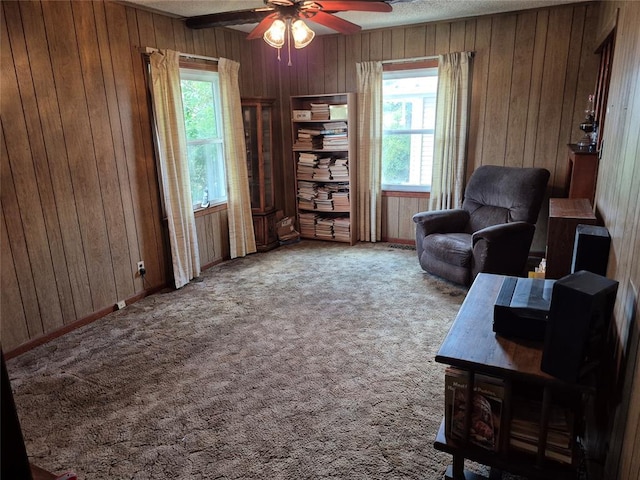 621 S 9th St, Yukon, OK 73099 - sitting room with wooden walls, a ceiling fan, a textured ceiling, and carpet floors