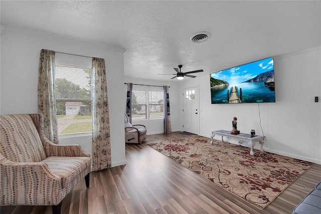 615 N Lowe, Hobart, OK 73651 - living area with wood finished floors, a textured ceiling, and ceiling fan