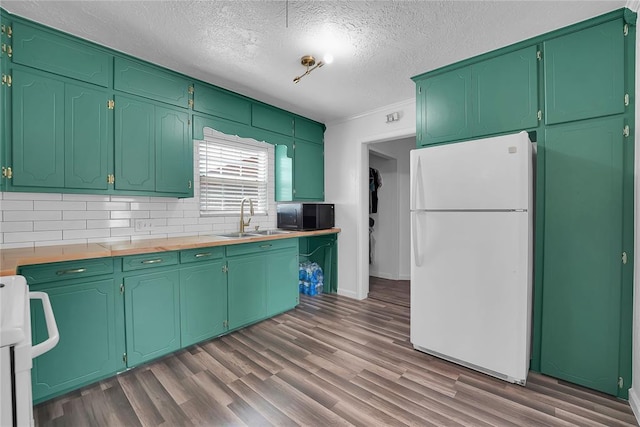 615 N Lowe, Hobart, OK 73651 - kitchen with freestanding refrigerator, black microwave, stove, dark wood-type flooring, and backsplash