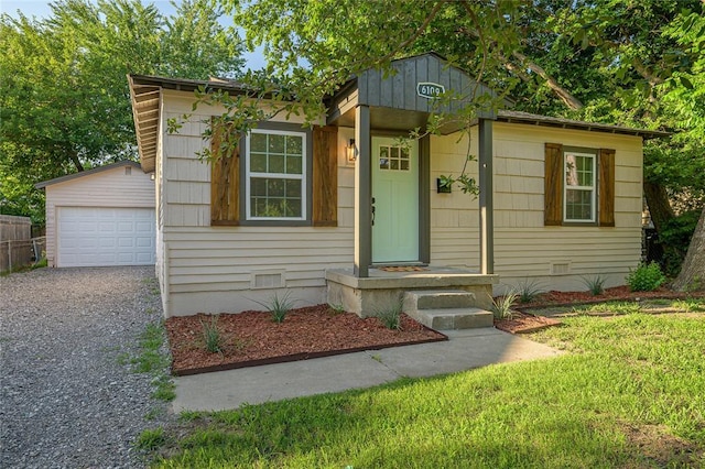 6109 NW 55th St, Oklahoma City, OK 73122 - view of front of home featuring an outdoor structure, crawl space, a garage, and gravel driveway