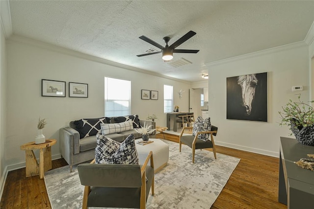 6109 NW 55th St, Oklahoma City, OK 73122 - living area featuring crown molding, a textured ceiling, ceiling fan, and dark wood-style flooring